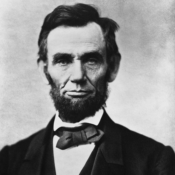 Black and white portrait of a historical figure wearing a suit and bow tie.