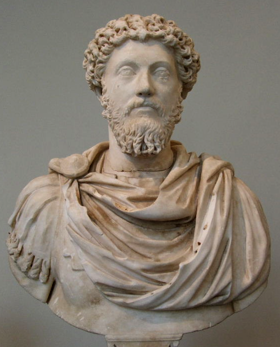 Marble bust of a bearded man with a draped garment against a neutral background - Marcus Aurelius